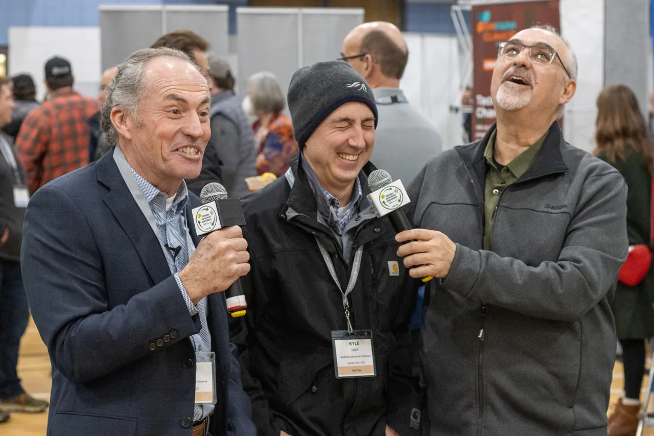 Peter and Albert sharing a laugh during a conference-floor interview